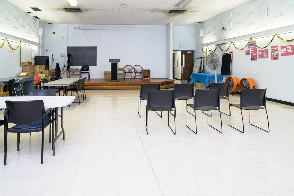Herring Run meeting room - chairs and tables, facing the stage