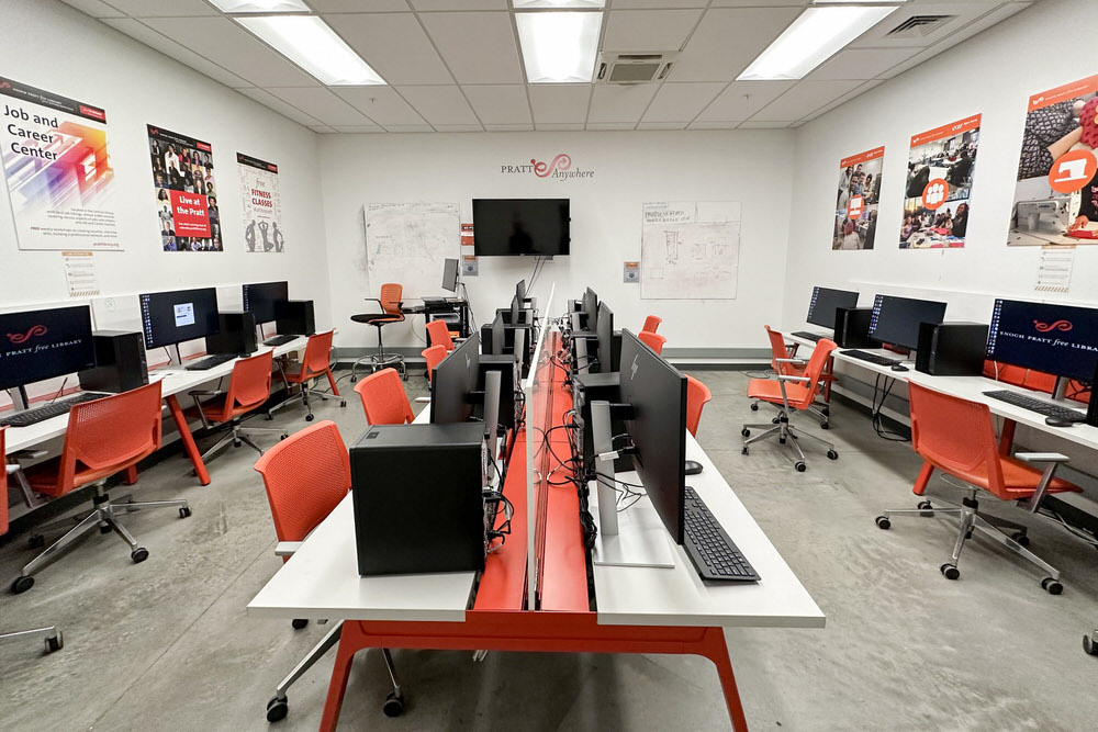 Open Works Technology Lab - Pratt Anywhere room with computers, tables, chairs, posters